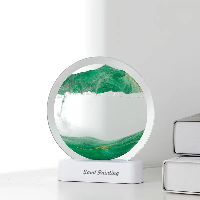 Lampe décorative sable mouvant 3D en version verte, posée sur bureau blanc — design élégant et moderne, parfaite comme objet de décoration zen ou cadeau original.