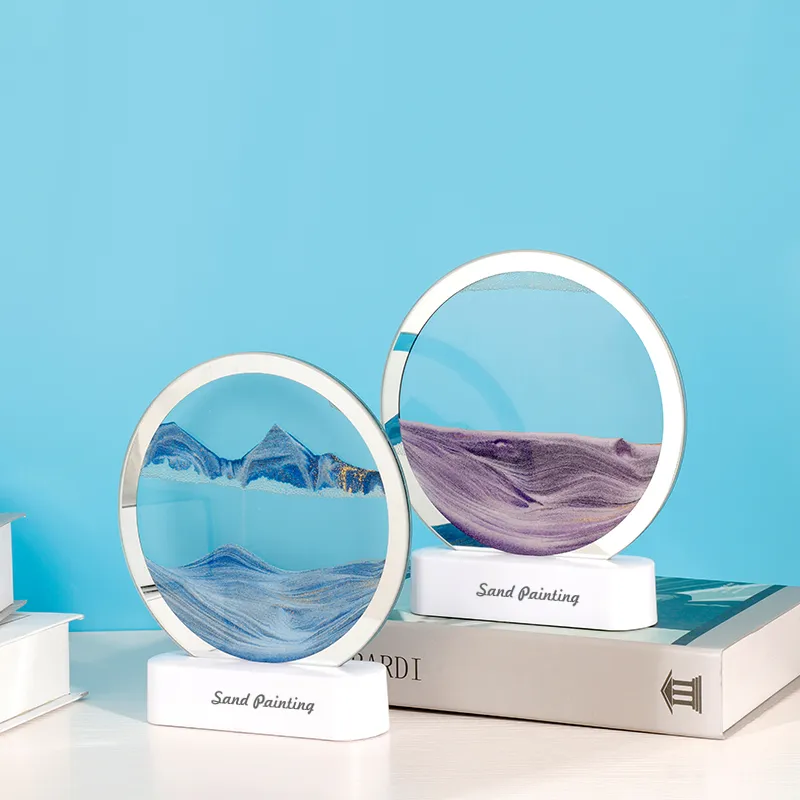 Deux lampes sable mouvant 3D (bleue et violette) présentées sur des livres — décoration intérieure tendance, idéale pour créer une ambiance relaxante et artistique.