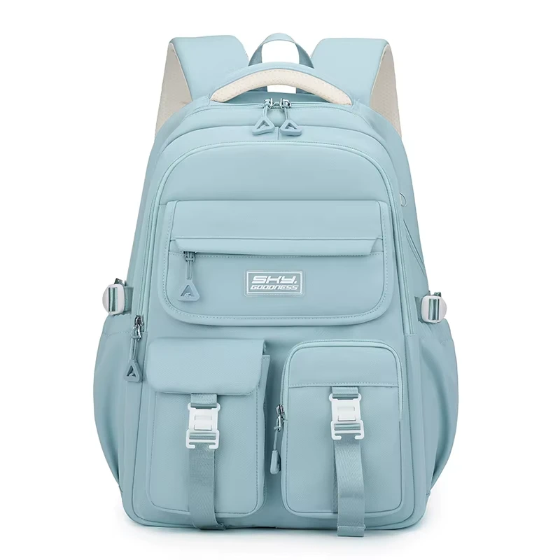 Sac à dos style coréen bleu ciel (menthe) grande capacité avec logo SHY GOODNESS, multiples poches avant à boucles blanches et bretelles rembourrées — mochila ergonomique et imperméable idéale pour le lycée, l'université et les voyages.
